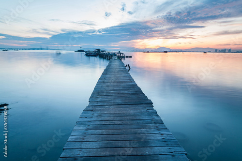 Real wooden bridge view of sunrise background © keongdagreat