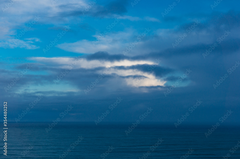Ocean seascape with blue water and clouds