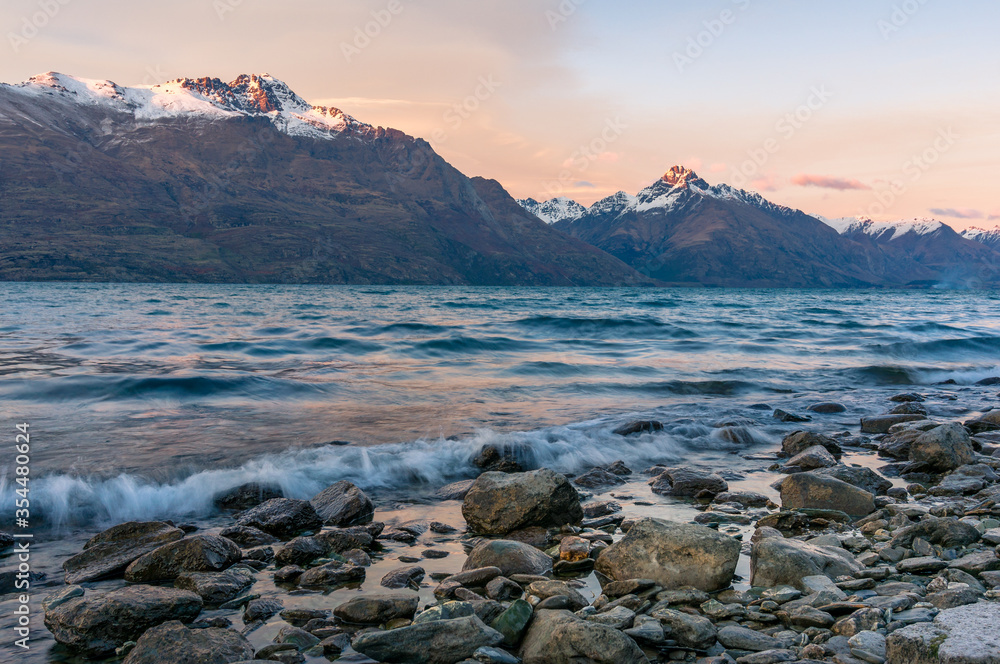 Winter mountain landscape with icy lake and snow-capped mountains Winter mountain landscape with icy lake and snow-capped mountains