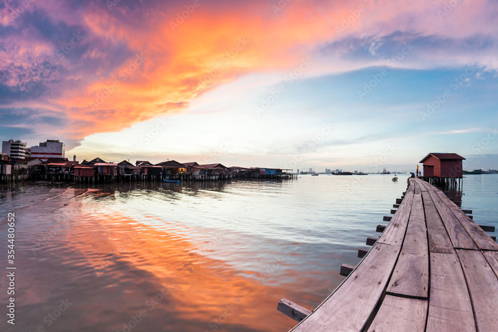 Fototapeta premium Wooden bridge Clan Tan Jetty view during sunrise in George Town, Penang