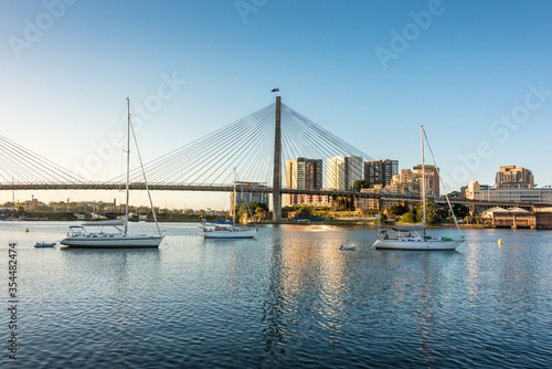 Sydney cityscape with harbor view, ANZAC bridge and boats © Olga K