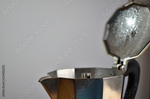 a metal coffee maker with white background