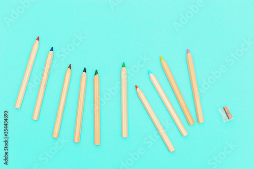 Wooden colored pencils. Social media and creativity background with copy space. Minimal style photography.