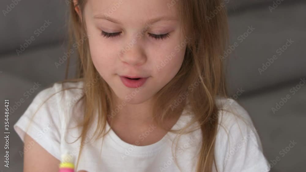Little blonde girl with blue eyes diligently brushes her teeth with an electric toothbrush. High quality 4k footage Little blonde girl with blue eyes diligently brushes her teeth with an electric toothbrush. High quality 4k footage