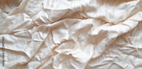 The white patterned fabric wrinkles using soft focus.