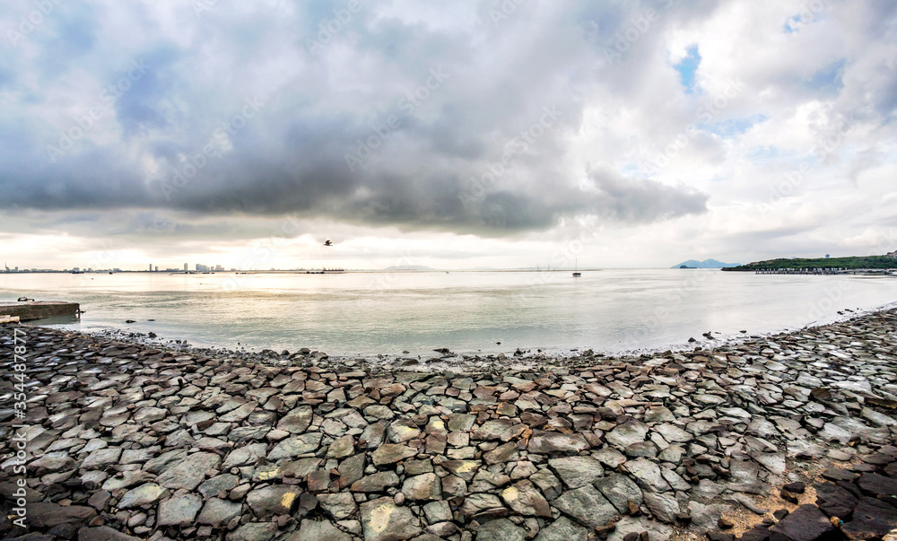 Rocky shore view with sunrise or sunset background Rocky shore view with sunrise or sunset background