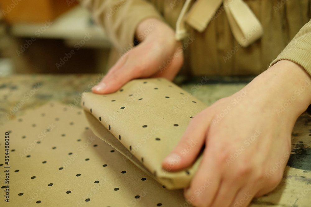 woman folds packing box in sewing workshop woman folds packing box in sewing workshop