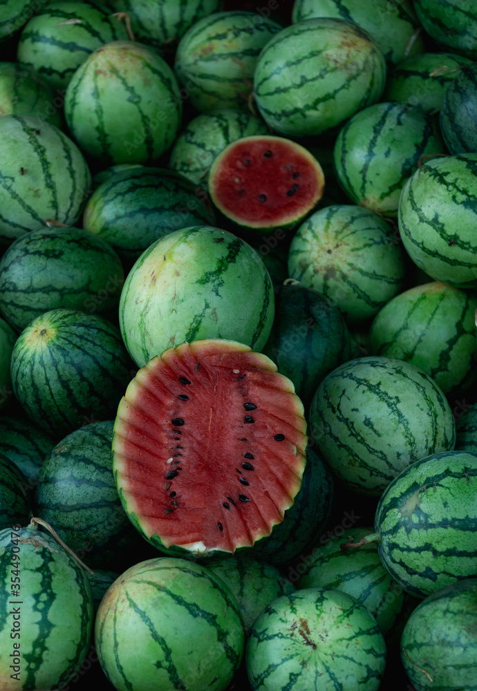 Pile of fresh ripe watermelons on a fruit market stall Pile of fresh ripe watermelons on a fruit market stall