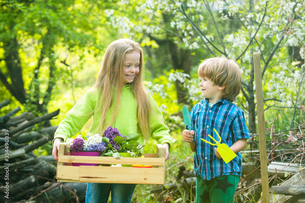 Eco living. Son and daughter planting on ground. Sweet childhood ...