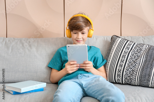 Cute little boy studying at...
