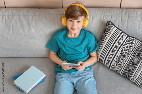 Cute little boy studying at...