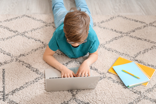 Cute little boy studying at...