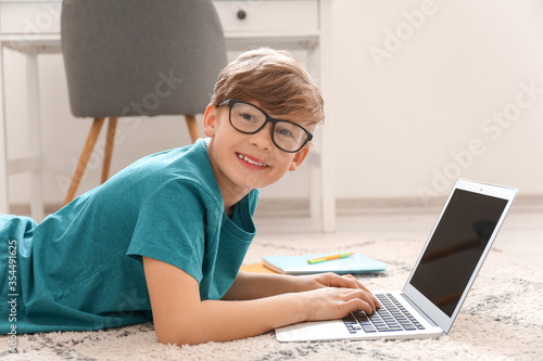 Cute little boy studying at...