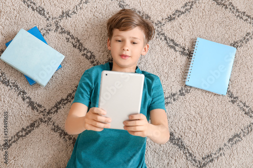 Cute little boy studying at...