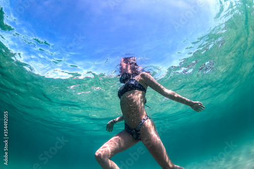 Young girl swimming in the crystal clear water  Bondi Beach  Australia
