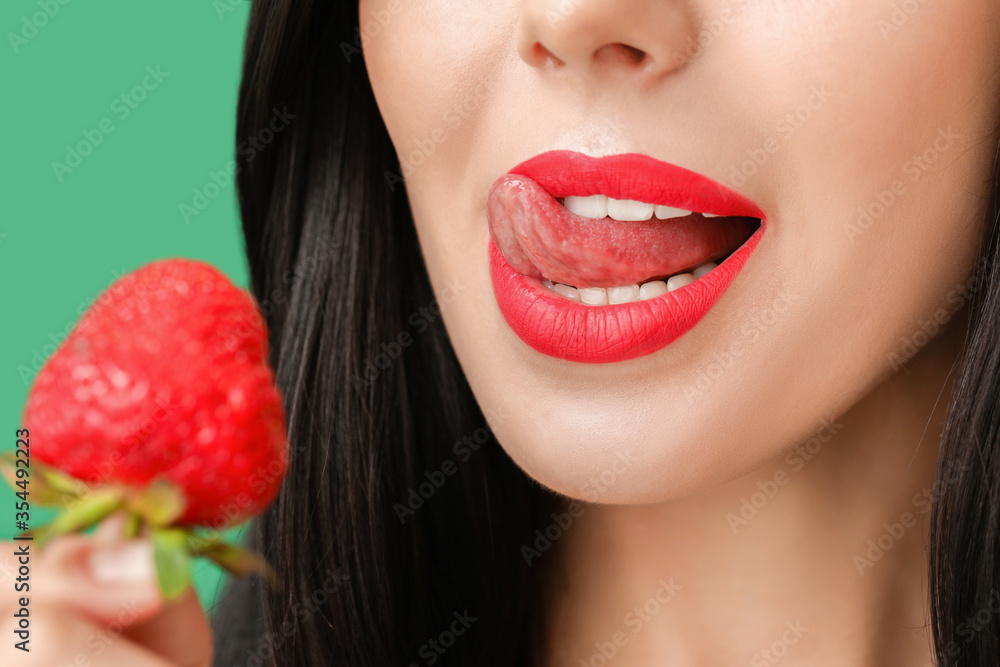 Sexy young woman with strawberry on color background, closeup Sexy young woman with strawberry on color background, closeup