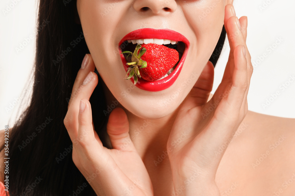 Sexy young woman with strawberry on white background Sexy young woman with strawberry on white background
