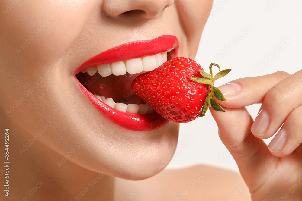 Sexy young woman with strawberry on white background, closeup Sexy young woman with strawberry on white background, closeup