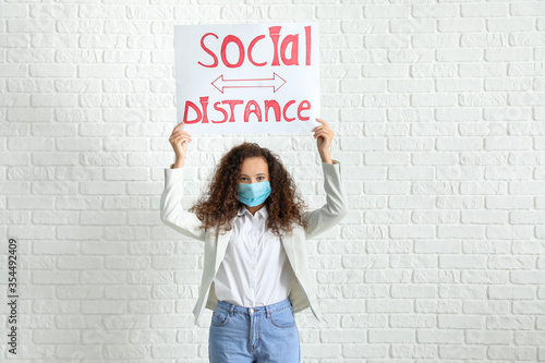 Young woman holding paper w...