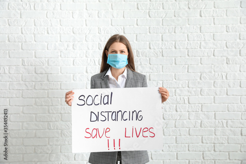 Young woman holding paper w...