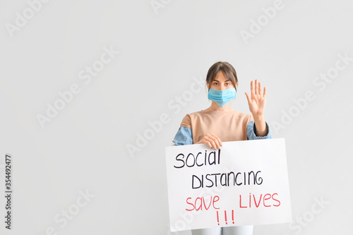 Young woman holding paper w...
