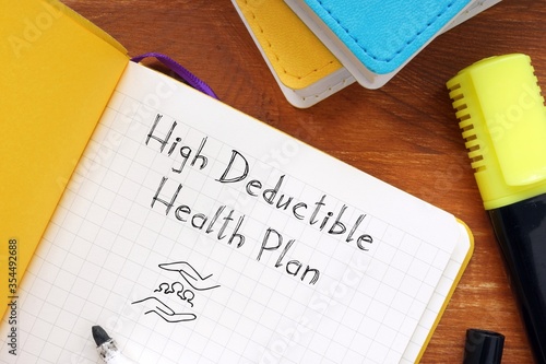 Business concept about high deductible health plan with sign on the piece of paper.