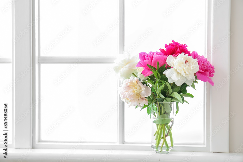 Vase with beautiful peony flowers on window sill Vase with beautiful peony flowers on window sill
