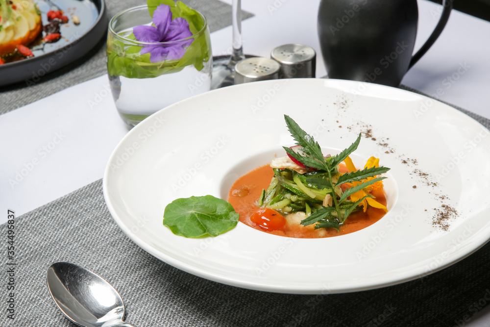 Healthy organic tomato soup. Modern creative restaurant meal. Exquisite dish, haute couture food.