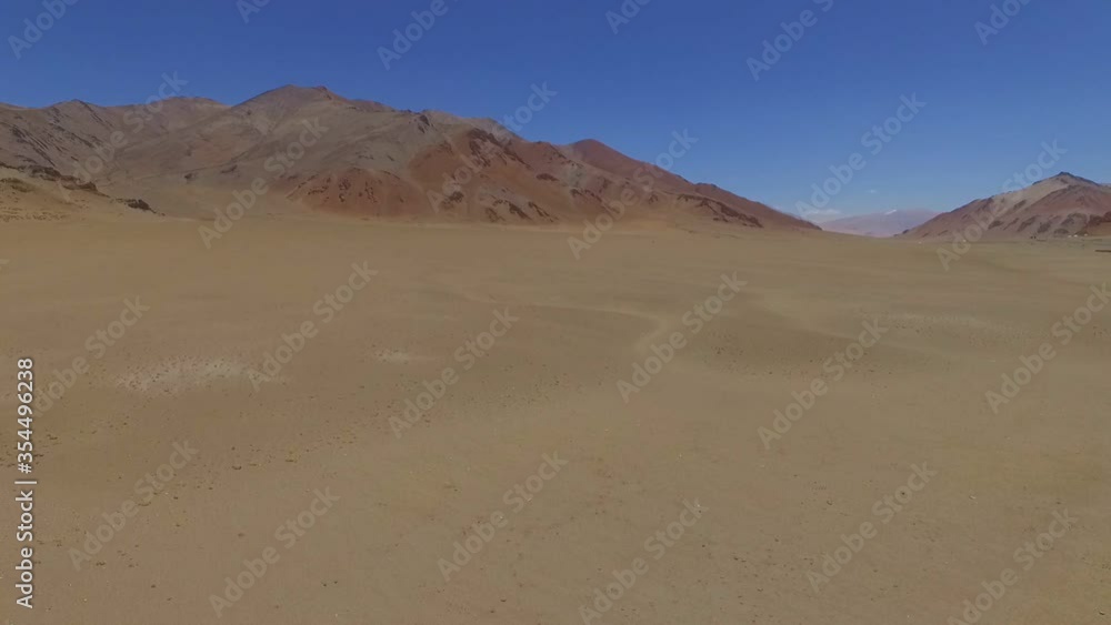 Low flight over endless high-altitude desert stony harsh plains in the Himalayas. Low flight over endless high-altitude desert stony harsh plains in the Himalayas.