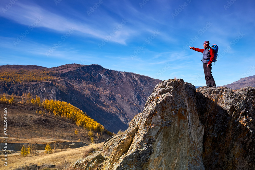 Man with backpack hiking in mountains. Travel Lifestyle success concept adventure active vacations outdoor mountaineering sport