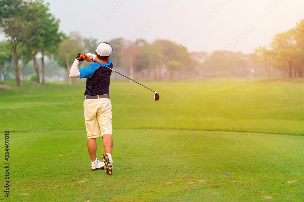 Man Golfer Hitting Ball with Club on Beatuiful Golf Course Man Golfer Hitting Ball with Club on Beatuiful Golf Course