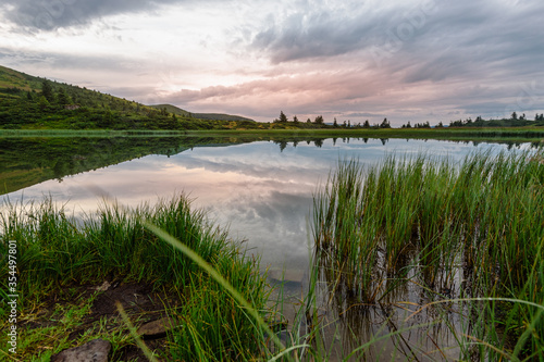 Carpathian mountains summer sunset landscape with pink clouds and river