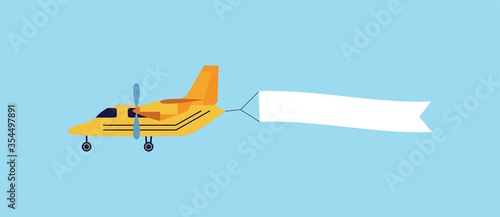 Vintage yellow airplane flying with blank white ribbon banner behind it