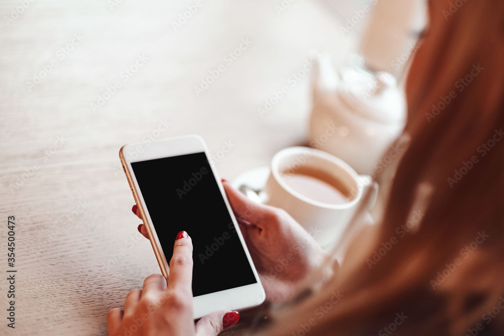 Business woman hands using smart phone and cup of coffee. Business woman hands using smart phone and cup of coffee.
