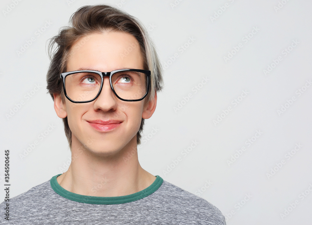© Raisa Kanareva - young man with emotions on his face a grey background © Raisa Kanareva - young man with emotions on his face a grey background