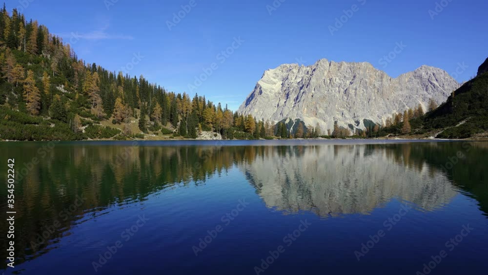 Stunning autumn mountain reflections in a tranquil lake. View of Zugspitze and Seebensee. Alps, Austria