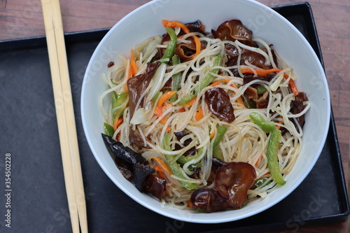 Rice noodles stir fry in bowl with ear wood mushrooms, vegetables