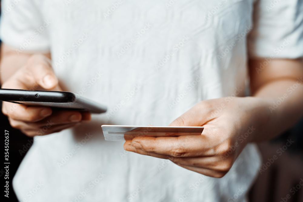 Online shopping concept. Young woman filling and paying order in online store application. Close-up view of unrecognizable female ordering food Online shopping concept. Young woman filling and paying order in online store application. Close-up view of unrecognizable female ordering food