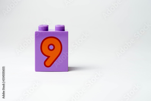 the number nine written on the block from the children's constructor