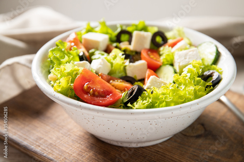 Plate with tasty greek salad on the table. Salad recipe