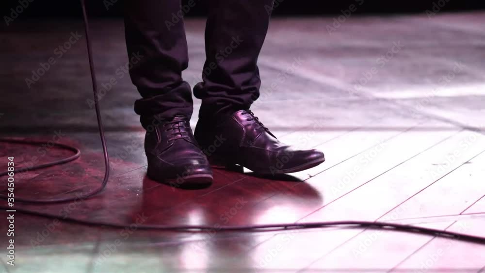 Singer feet tapping and moving to the music during bar concert, tapping on the wooden floor Singer feet tapping and moving to the music during bar concert, tapping on the wooden floor