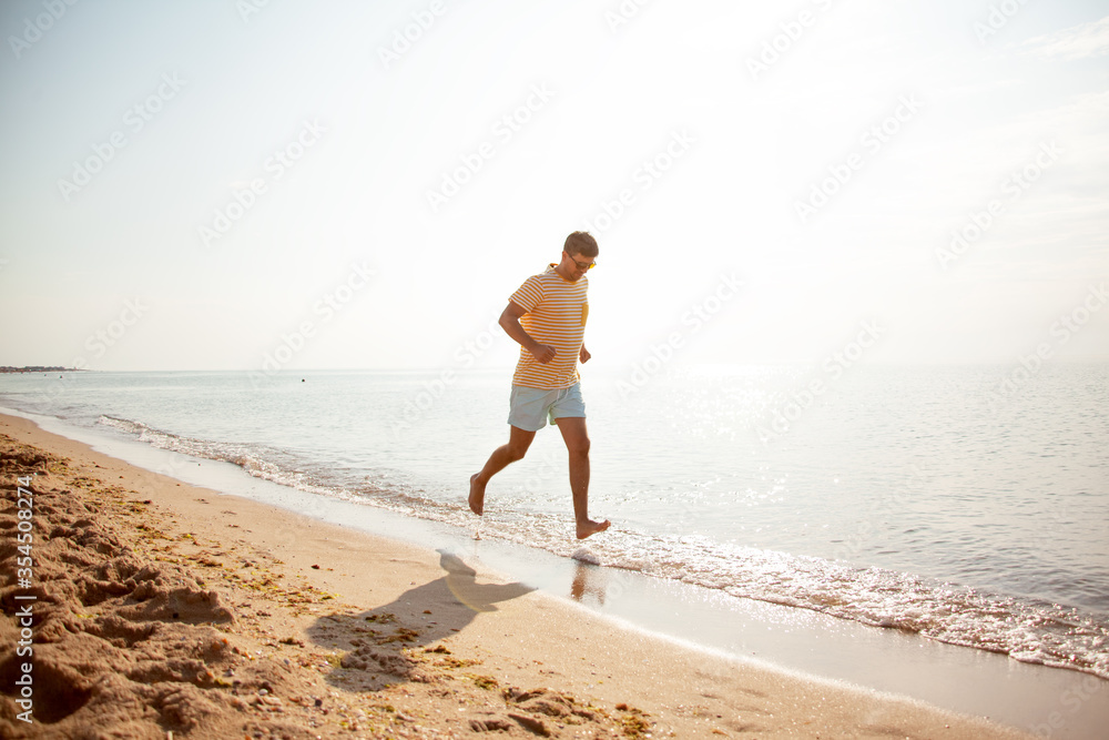 35 years old man running on the sandy beach