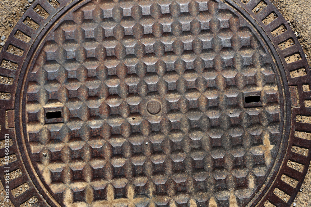 Old rusty metal street sewer drain cover top hatch texture