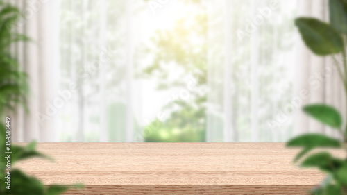 Obraz na plátně Empty wood table and blurred kitchen background , consisting of curtains and plants