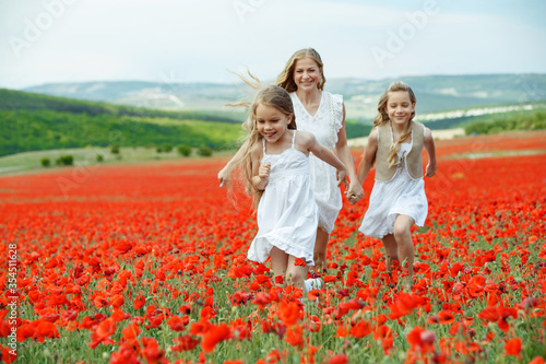 Woman with children in a field with flowers. Beautiful family on the nature. 