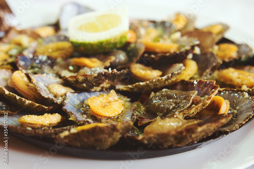 A Madeiran specialty, the limpets “Lapas” are cooked in a frying pan of their own. The taste increases when splashed with fresh lemon and butter.  photo