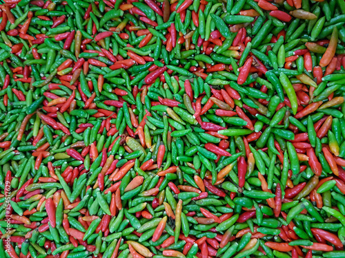 Green and red small thai chili peppers background