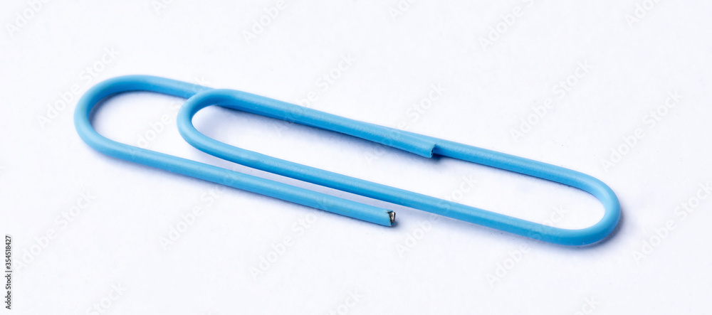 Colored paper clips close-up on a white background Colored paper clips close-up on a white background
