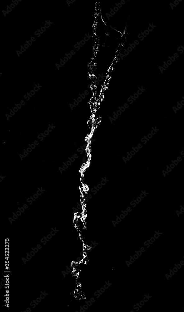 Splashes and drops of water are on a black background. Splashes and drops of water are on a black background.