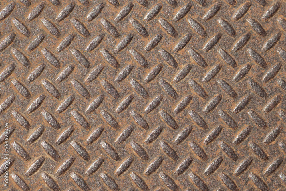 Oval pattern on the surface of the iron rusty walls, which are used as a door or gate because of its sturdy. Closeup. Oval pattern on the surface of the iron rusty walls, which are used as a door or gate because of its sturdy. Closeup.